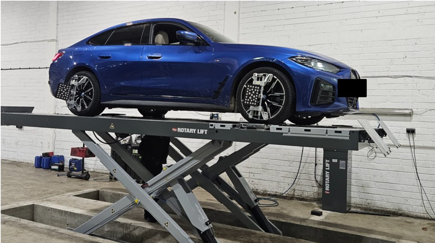 A car on Ace Tyres' Rotary Lift wheel alignment rig, with camera-based alignment sensors clamped to the wheels